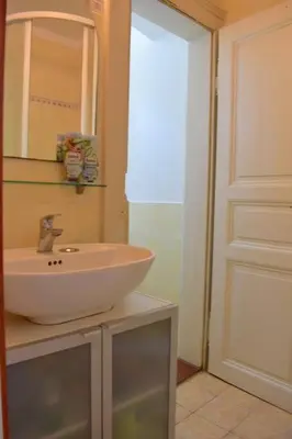 a bathroom with a sink and a mirror and a door at Authentic, traditional airbnb in central Prague ! in Prague