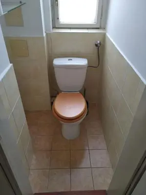 a small bathroom with a toilet with a window at Authentic, traditional airbnb in central Prague ! in Prague