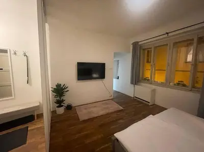 a living room with a tv on the wall at Prahabel - K10 in Prague