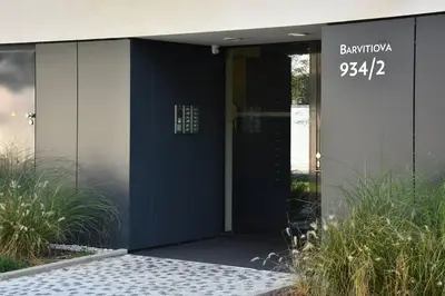 a blue door of a building with a clock on it at Appartment Waltrovka, free parking in Prague