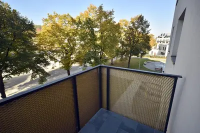 a balcony with a view of a street and trees at Appartment Waltrovka, free parking in Prague