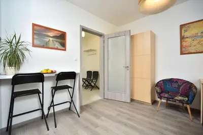 a room with a table and two chairs and a door at Appartment Waltrovka, free parking in Prague