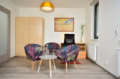 a living room with three chairs and a table at Appartment Waltrovka, free parking in Prague