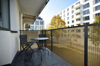 a balcony with two chairs and a table on a balcony at Appartment Waltrovka, free parking in Prague