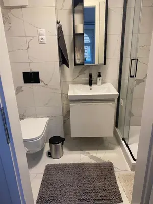a bathroom with a sink and a toilet and a mirror at Apartment Prague Center in Prague