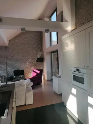 a kitchen with a counter top and a staircase at Centrum luxury nice wiew, theras in Prague