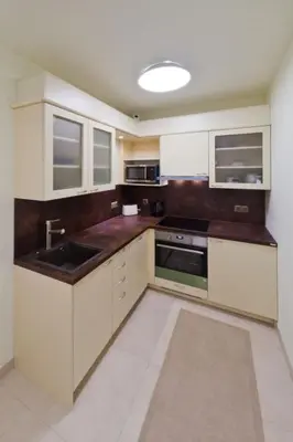 a kitchen with white cabinets and a sink at Havelska Old Town Residence in Prague