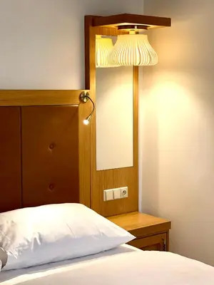 a bedroom with a bed with a mirror and a lamp at Havelska Old Town Residence in Prague