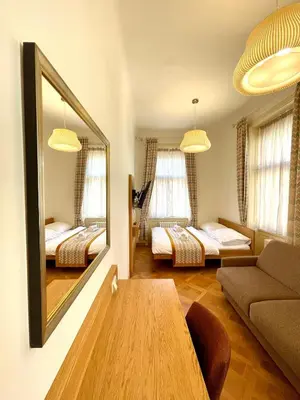 a living room with two beds and a mirror at Havelska Old Town Residence in Prague