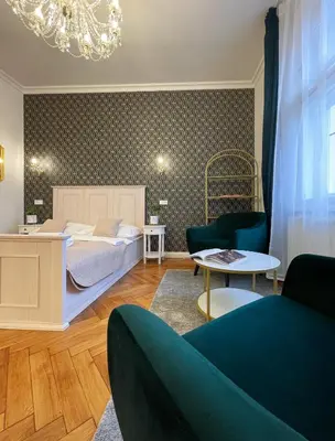 a bedroom with a bed and a living room at Stupartska - Premium Old Town Residence in Prague