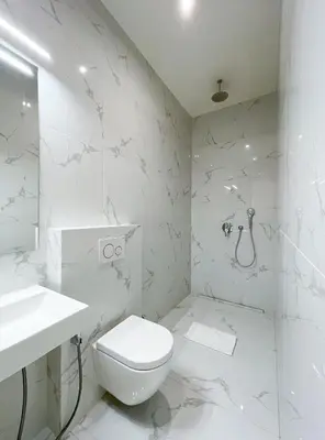 a white bathroom with a toilet and a sink at Stupartska - Premium Old Town Residence in Prague