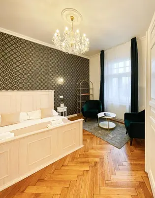 a living room with a couch and a chandelier at Stupartska - Premium Old Town Residence in Prague