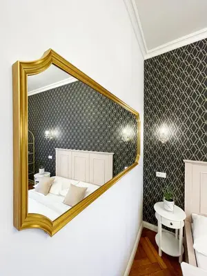 a bedroom with a mirror on the wall at Stupartska - Premium Old Town Residence in Prague
