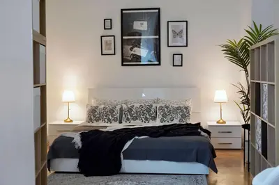 a bedroom with a large bed and two lamps at NEW! Mucha 3BDR Flat in HEART of the City Center in Prague