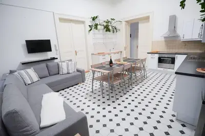 a living room with a couch and a table in a kitchen at NEW! Mucha 3BDR Flat in HEART of the City Center in Prague