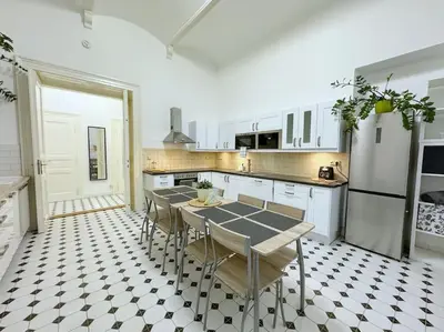 a kitchen with a table and chairs in it at NEW! Mucha 3BDR Flat in HEART of the City Center in Prague