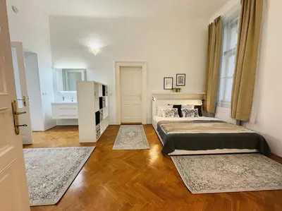 a bedroom with two beds and two rugs at NEW! Mucha 3BDR Flat in HEART of the City Center in Prague