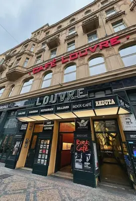 a building with a louvre sign on the front of it at NEW! Mucha 3BDR Flat in HEART of the City Center in Prague