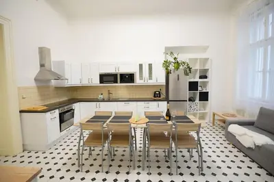 a kitchen with a table and chairs in a room at NEW! Mucha 3BDR Flat in HEART of the City Center in Prague