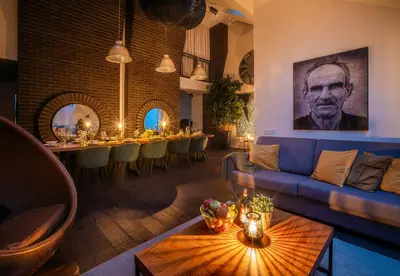 a living room with a blue couch and a table at 5BR+2Bath Old Town Loft Luxe Brickhouse, A/C in Prague