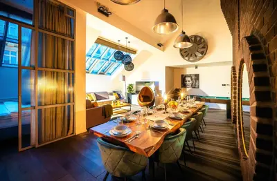 a dining room with a long table and chairs at 5BR+2Bath Old Town Loft Luxe Brickhouse, A/C in Prague