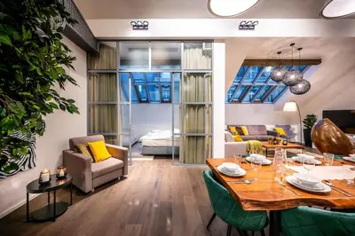 a living room with a table and a dining room at 5BR+2Bath Old Town Loft Luxe Brickhouse, A/C in Prague