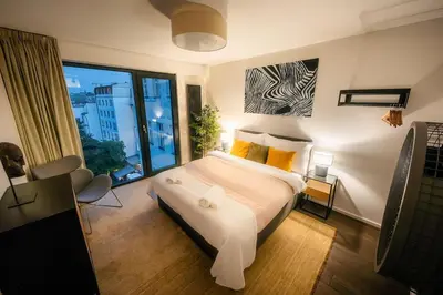 a bedroom with a bed and a large window at 5BR+2Bath Old Town Loft Luxe Brickhouse, A/C in Prague