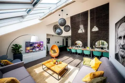 a living room with a couch and a table at 5BR+2Bath Old Town Loft Luxe Brickhouse, A/C in Prague