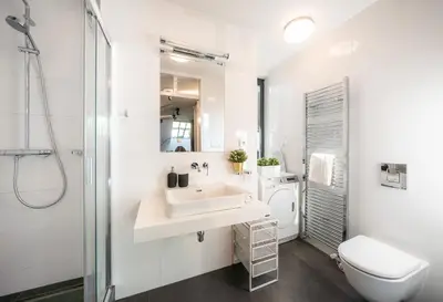 a white bathroom with a sink and a toilet at 5BR+2Bath Old Town Loft Luxe Brickhouse, A/C in Prague