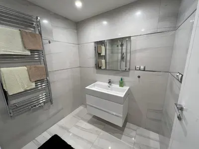 a white bathroom with a sink and a shower at Quiet apartment in the centre in Prague