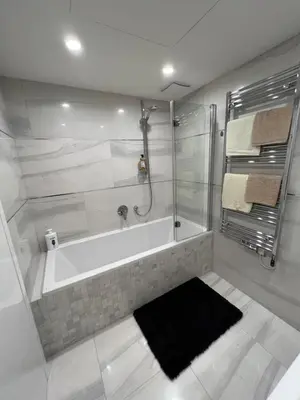 a bathroom with a tub and a glass shower at Quiet apartment in the centre in Prague