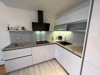 a kitchen with white cabinets and a counter top at Quiet apartment in the centre in Prague