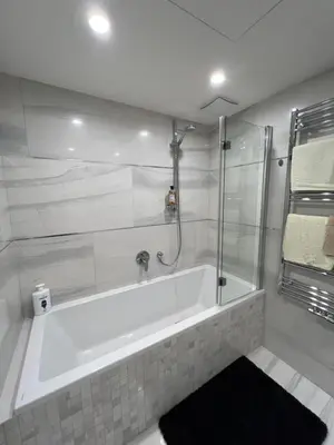 a white bathroom with a tub and a shower at Quiet apartment in the centre in Prague