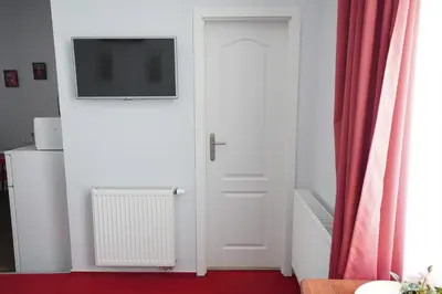 a white door with a television on top of it at Elegant & Stylish Center Apartments! in Prague