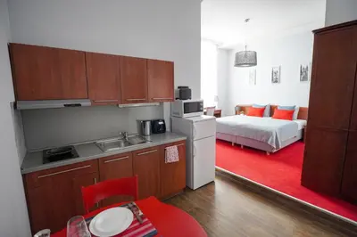 a kitchen and a bedroom with a bed in a room at Elegant & Stylish Center Apartments! in Prague