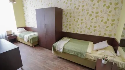 a bedroom with two beds and a cabinet with a wallpaper at Elegant & Stylish Center Apartments! in Prague
