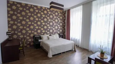 a bedroom with a bed and a floral wall at Elegant & Stylish Center Apartments! in Prague