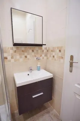a bathroom with a sink and a mirror at Elegant & Stylish Center Apartments! in Prague