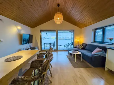 a living room with a couch and a table at Houseboat Franklin - Houseboats Benjamin & Franklin in Prague