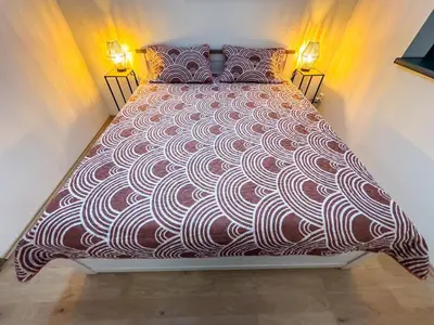 a large bed in a room with two lights at Houseboat Franklin - Houseboats Benjamin & Franklin in Prague