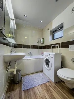a bathroom with a sink and a washing machine at Houseboat Franklin - Houseboats Benjamin & Franklin in Prague