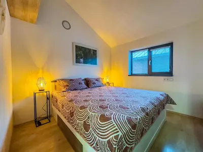 a bedroom with a bed and a clock on the wall at Houseboat Franklin - Houseboats Benjamin & Franklin in Prague
