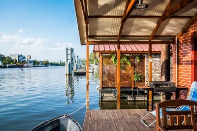 a house on a dock on a body of water at Houseboat Benjamin - Houseboats Benjamin & Franklin in Prague