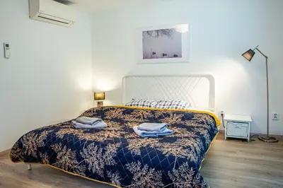 a bedroom with a bed with two towels on it at Houseboat Benjamin - Houseboats Benjamin & Franklin in Prague