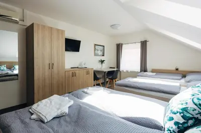 a bedroom with two beds and a desk at Ubytování Kytín in Kytín