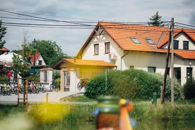 a house with an orange roof with bikes parked outside at Ubytování Kytín in Kytín