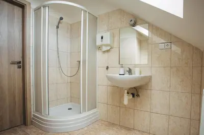 a bathroom with a sink and a shower at Ubytování Kytín in Kytín