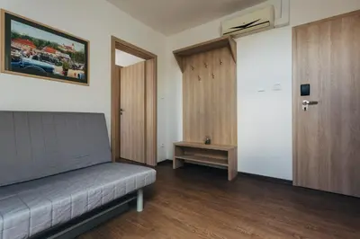 a room with a couch and a door and a table at Ubytování Kytín in Kytín
