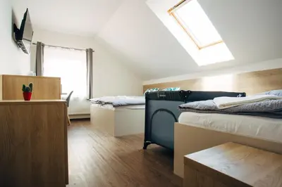 a dorm room with two beds and a skylight at Ubytování Kytín in Kytín
