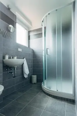 a bathroom with a sink and a glass shower at Ubytování Kytín in Kytín